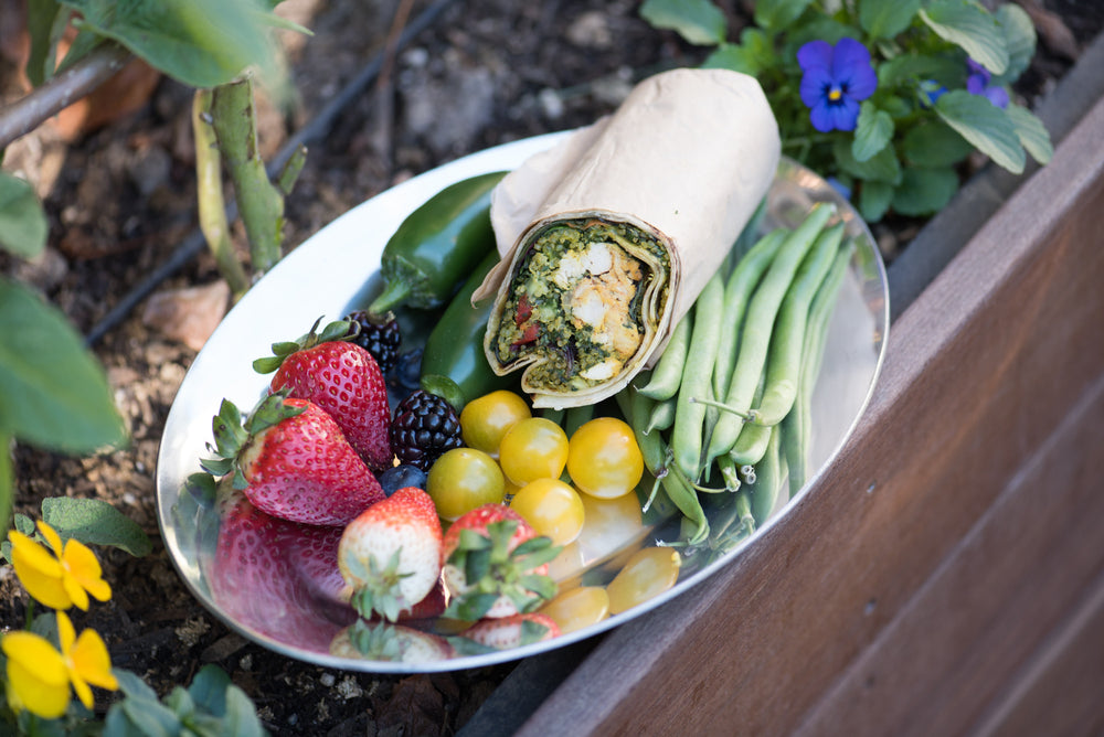 a kreation wrap surrounded by fruits and vegetables 